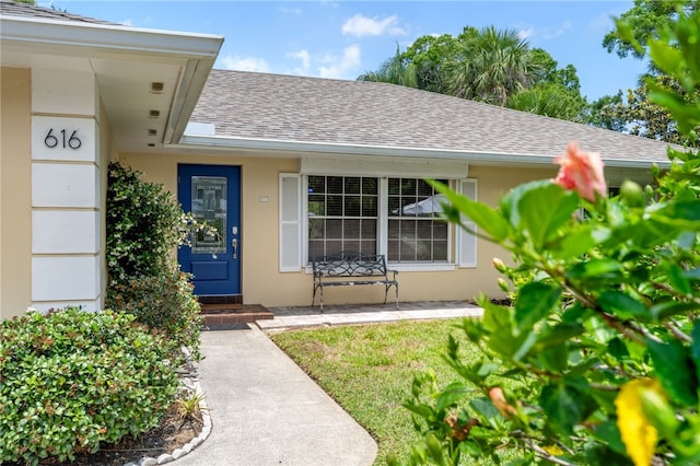 616 Broadway St, Vero Beach, FL 32960 - entrance to property featuring roof with shingles and stucco siding