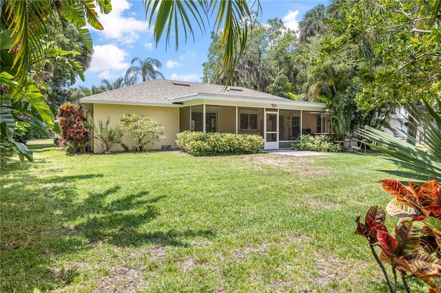 616 Broadway St, Vero Beach, FL 32960 - back of house featuring stucco siding, a sunroom, a lawn, and roof with shingles