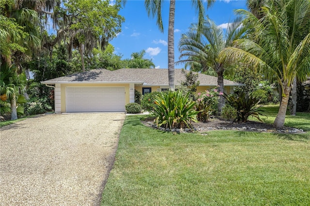 616 Broadway St, Vero Beach, FL 32960 - view of front facade with concrete driveway, an attached garage, and a front yard