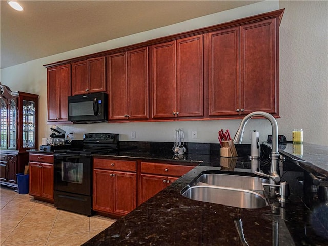 6243 Thames Pl, Vero Beach, FL 32966 - kitchen featuring black appliances, light tile patterned floors, dark stone counters, dark brown cabinets, and a textured wall