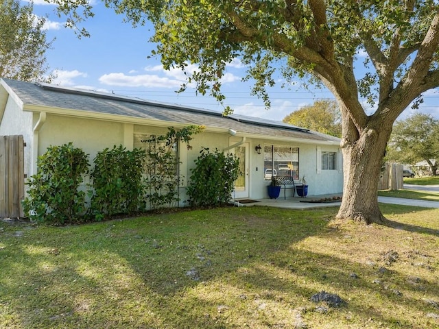 rear view of house featuring a lawn