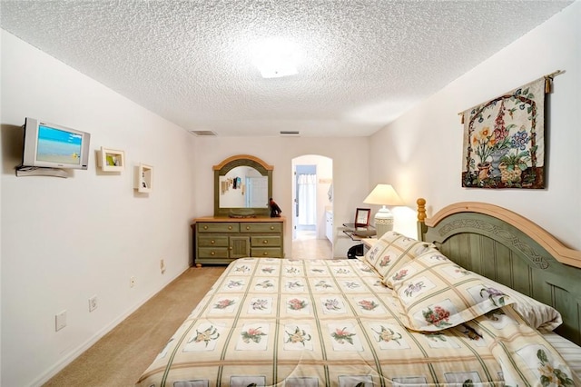 carpeted bedroom featuring a textured ceiling