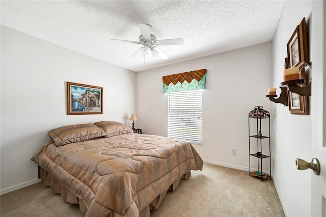 carpeted bedroom featuring a textured ceiling and ceiling fan