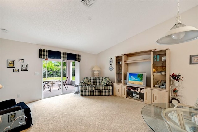 carpeted living room featuring vaulted ceiling and a textured ceiling