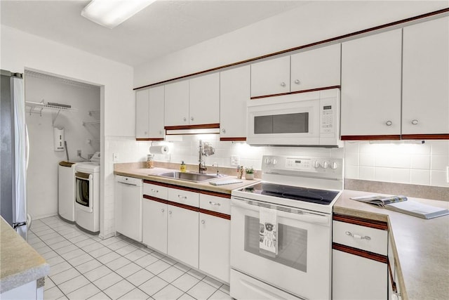 737 Timber Ridge Trl SW Unit B, Vero Beach, FL 32962 - kitchen featuring white appliances, separate washer and dryer, light countertops, and tasteful backsplash