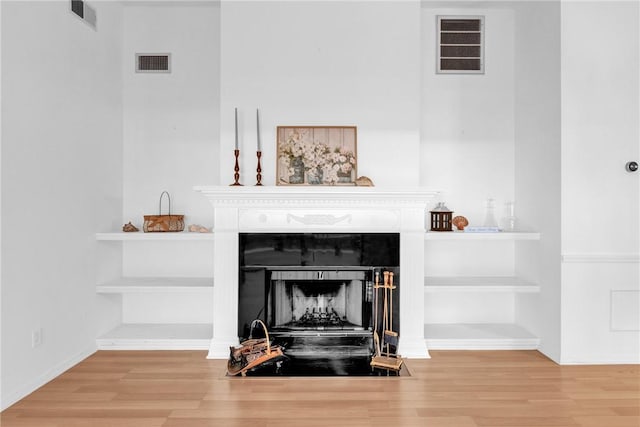 737 Timber Ridge Trl SW Unit B, Vero Beach, FL 32962 - detailed view of wood finished floors and a fireplace with flush hearth