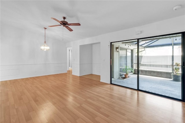 737 Timber Ridge Trl SW Unit B, Vero Beach, FL 32962 - unfurnished room with ceiling fan, light wood-style flooring, a smoke detector, a chandelier, and wainscoting