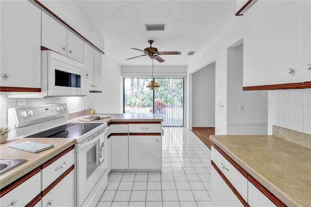 737 Timber Ridge Trl SW Unit B, Vero Beach, FL 32962 - kitchen featuring white appliances, light tile patterned floors, a peninsula, and light countertops