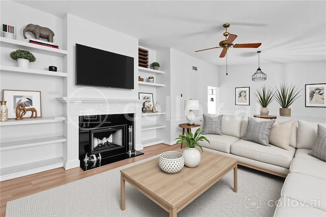 737 Timber Ridge Trl SW Unit B, Vero Beach, FL 32962 - living room with wood finished floors, ceiling fan, built in shelves, and a fireplace with raised hearth