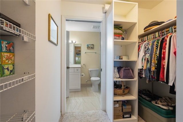 spacious closet featuring visible vents