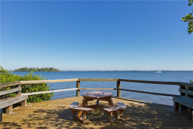 dock area with a deck with water view