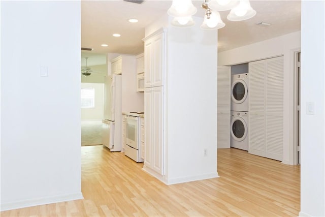 washroom featuring visible vents, laundry area, light wood-style flooring, recessed lighting, and stacked washer and dryer