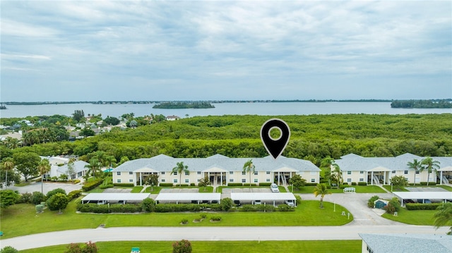 drone / aerial view featuring a residential view and a water view