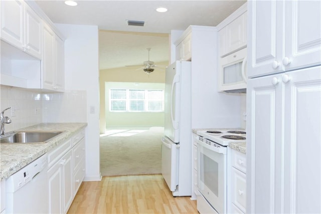 kitchen with white cabinetry, white appliances, light countertops, and a sink