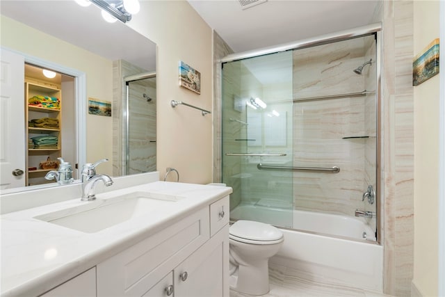 bathroom featuring vanity, toilet, visible vents, and combined bath / shower with glass door