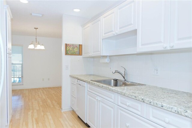 kitchen featuring white appliances, white cabinets, sink, light hardwood / wood-style flooring, and ceiling fan