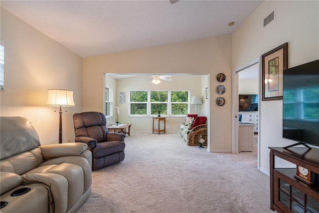 carpeted living room featuring visible vents, lofted ceiling, baseboards, and ceiling fan