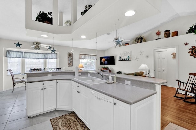 kitchen with open floor plan, a ceiling fan, a sink, and dishwasher