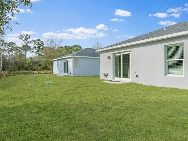 back of house with a lawn