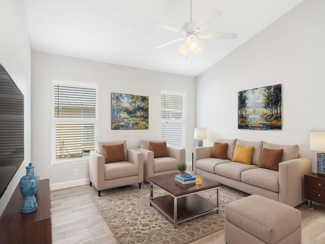 living room with lofted ceiling, ceiling fan, and light hardwood / wood-style flooring