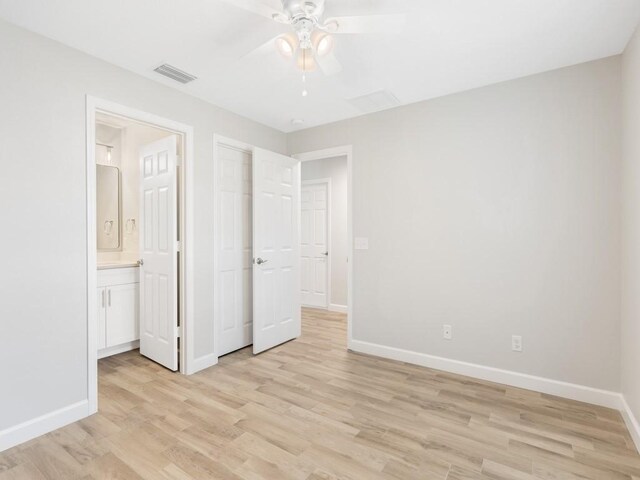 unfurnished bedroom featuring connected bathroom, ceiling fan, and light wood-type flooring