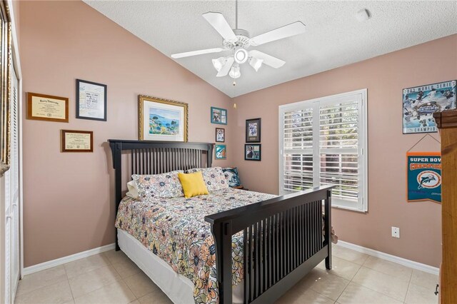 881 Foster Ave, Sebastian, FL 32958 - tiled bedroom featuring vaulted ceiling, a textured ceiling, and a ceiling fan