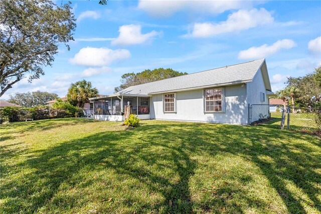 881 Foster Ave, Sebastian, FL 32958 - rear view of property featuring a sunroom and a gate