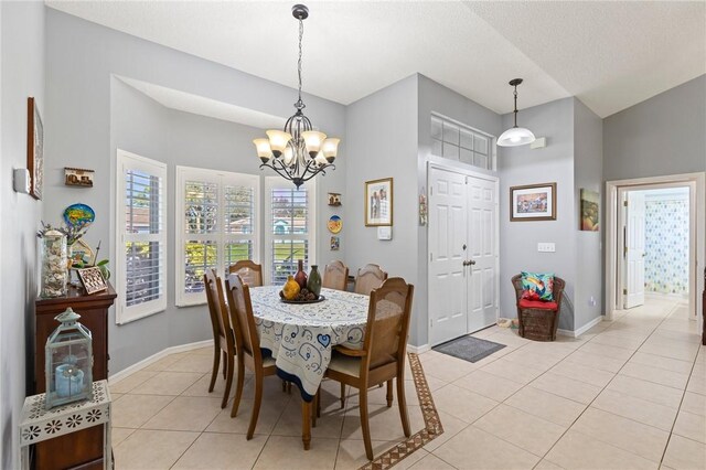 881 Foster Ave, Sebastian, FL 32958 - dining area featuring light tile patterned floors and a chandelier