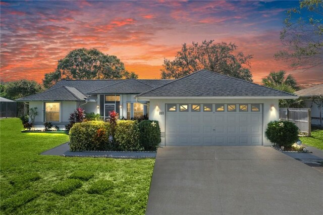 881 Foster Ave, Sebastian, FL 32958 - ranch-style house with stucco siding, a garage, and concrete driveway