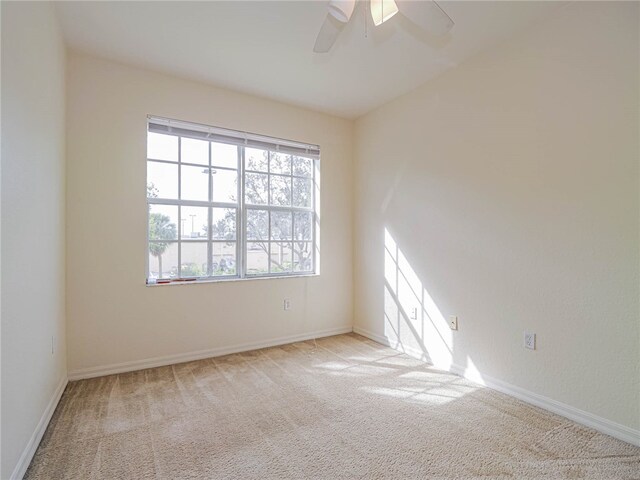 unfurnished room with ceiling fan and light carpet