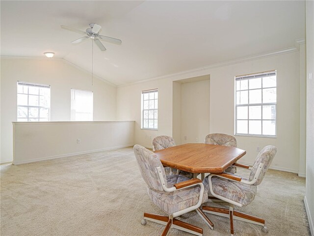 dining area featuring vaulted ceiling, light carpet, and crown molding