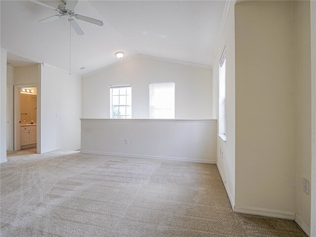 carpeted spare room with ceiling fan and lofted ceiling