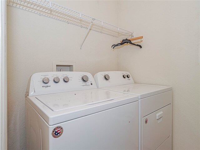 laundry area with separate washer and dryer