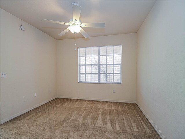 spare room with carpet flooring and ceiling fan