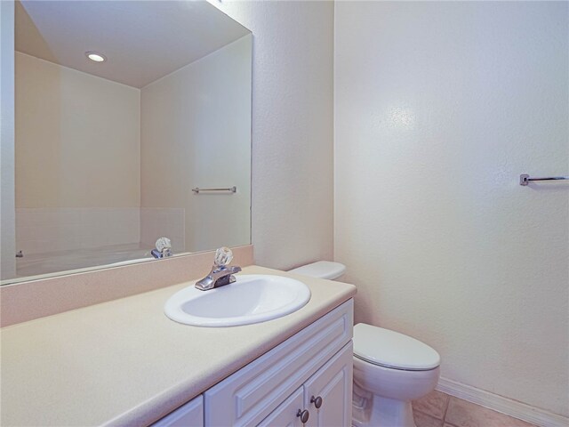 bathroom with vanity, toilet, and tile patterned flooring