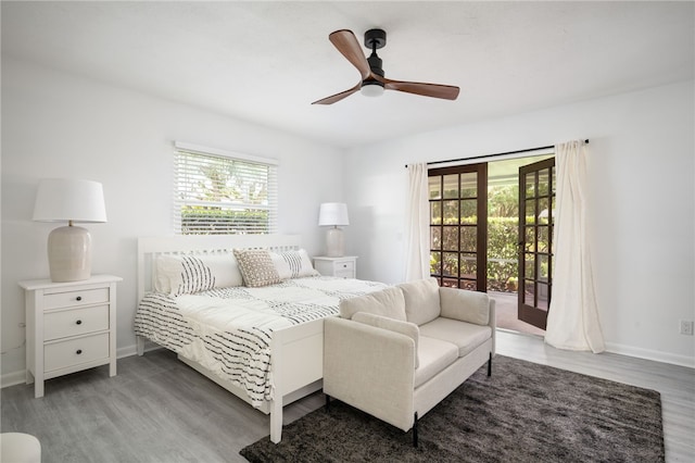 bedroom featuring ceiling fan, wood-type flooring, and access to outside