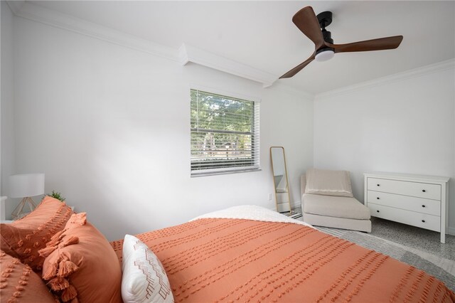 carpeted bedroom featuring ceiling fan and crown molding