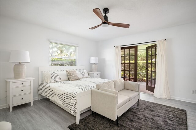 bedroom with ceiling fan, access to exterior, and hardwood / wood-style floors