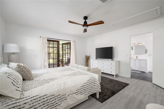 bedroom with ceiling fan, hardwood / wood-style flooring, and ensuite bath