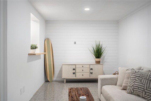 sitting room featuring wooden walls