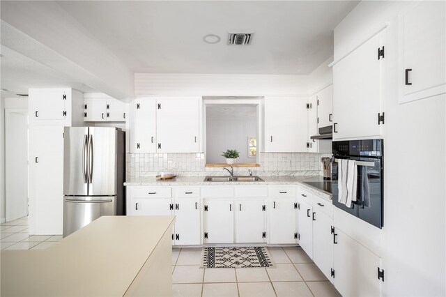 kitchen with light tile patterned flooring, sink, white cabinets, and black appliances