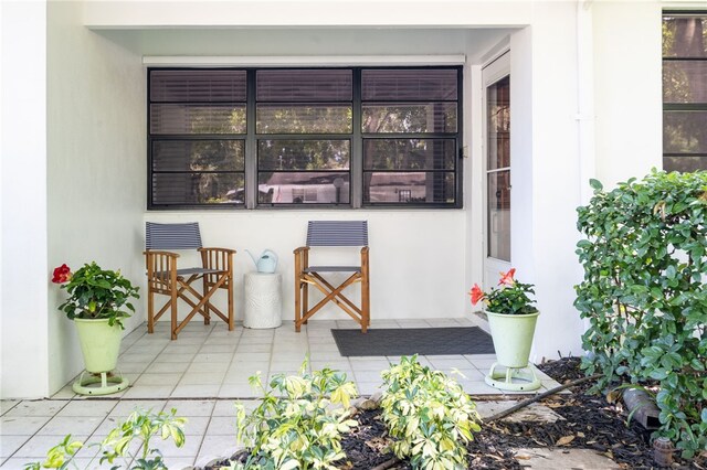 view of exterior entry with a patio