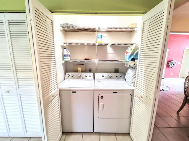 laundry area with light tile patterned flooring and washing machine and clothes dryer