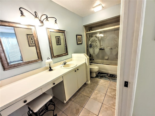 full bathroom featuring toilet, tile patterned floors, vanity, and tiled shower / bath