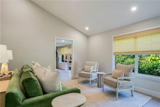 living room with vaulted ceiling and light hardwood / wood-style floors