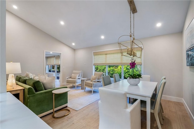 dining space featuring light hardwood / wood-style flooring and vaulted ceiling