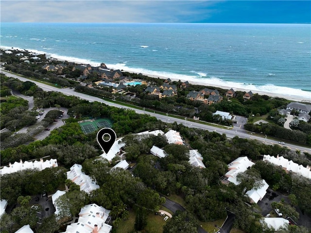 drone / aerial view featuring a water view and a view of the beach