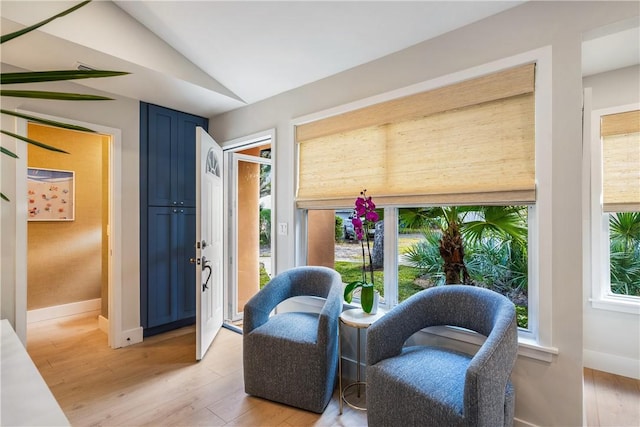 sitting room with light hardwood / wood-style flooring and lofted ceiling