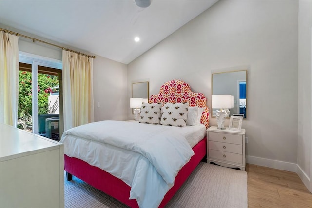 bedroom featuring light hardwood / wood-style floors and lofted ceiling