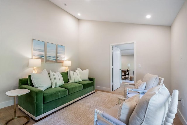 living room with vaulted ceiling and light hardwood / wood-style floors